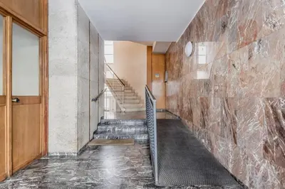 a hallway with stairs and a stone wall at Tiburtina White House in Rome