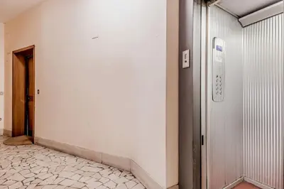 an empty hallway with a door and a tile floor at Tiburtina White House in Rome