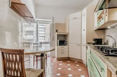 a kitchen with a island in the middle of a room at Tiburtina White House in Rome
