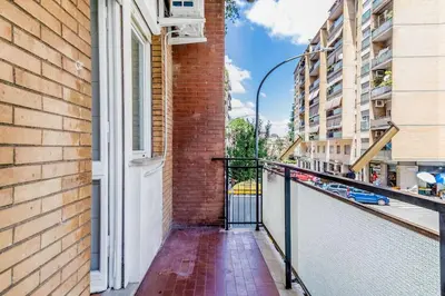 a balcony with a window and a brick building at Tiburtina White House in Rome