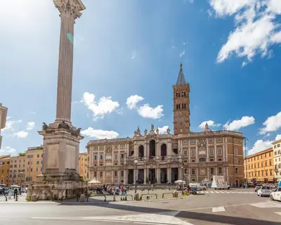 a large building with a column and a clock tower at Oscar Apt near Landmarks and Colosseum in Rome
