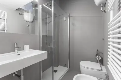 a bathroom with a toilet and a sink and a shower at Oscar Apt near Landmarks and Colosseum in Rome