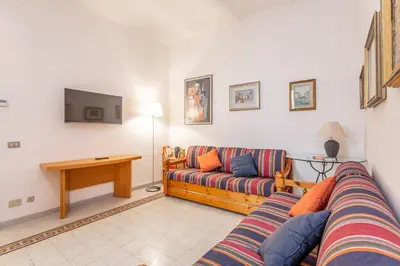 a living room with a couch and a tv at Oscar Apt near Landmarks and Colosseum in Rome