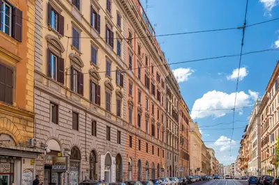 a city street with tall buildings and a blue sky at Oscar Apt near Landmarks and Colosseum in Rome