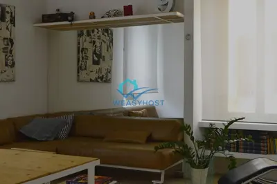 a living room with a couch and a table at Cozy Design Flat - Trastevere in Rome