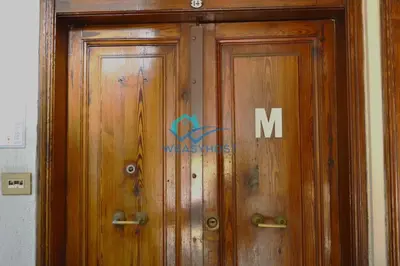 a wooden door with the letter m on it at Cozy Design Flat - Trastevere in Rome