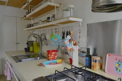 a kitchen counter with a sink and utensils at Cozy Design Flat - Trastevere in Rome