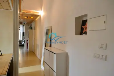 a kitchen with a white refrigerator and a hallway at Cozy Design Flat - Trastevere in Rome