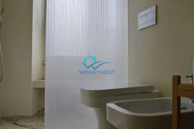 a bathroom with a sink and a toilet and a sign at Cozy Design Flat - Trastevere in Rome