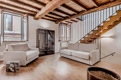 a living room with two chairs and a staircase at APT ROME - Vittoria Palace in Rome