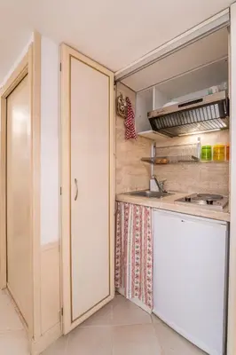 a small kitchen with a sink and a counter at Studio d'Artista, Elegante Loft nel Cuore di Roma in Rome