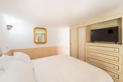 a bedroom with a bed and a flat screen tv at Studio d'Artista, Elegante Loft nel Cuore di Roma in Rome