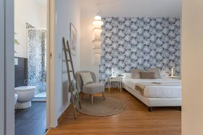 a bedroom with a bed and a bathroom at Minerva - Elegant New Classic close to Vatican in Rome