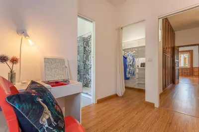 a living room with a red couch and a walk in closet at Minerva - Elegant New Classic close to Vatican in Rome