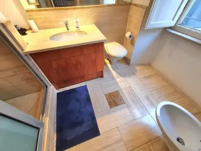 a bathroom with a sink and a toilet at Holiday Room Naiadis in Rome