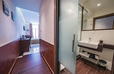 a bathroom with a sink and a mirror at Corso Grand Suite in Rome