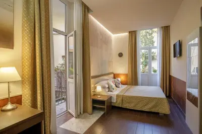 a bedroom with a bed and a window at Corso Grand Suite in Rome