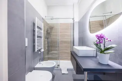 a bathroom with a toilet and a sink and a mirror at MHouse Roma in Rome