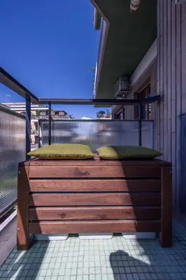 a bed on a balcony with two pillows on it at MHouse Roma in Rome