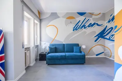 a blue chair in a room with a basketball wall at MHouse Roma in Rome