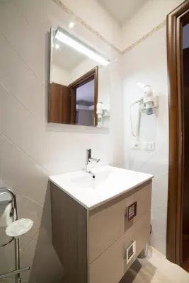 a bathroom with a sink and a mirror at Di Fronte alla Cupola in Rome