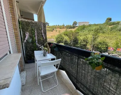 a patio with a table and chairs on a balcony at Ammiragli Vatican Experience in Rome
