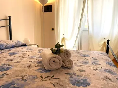 a bed with a pile of towels on it at Ammiragli Vatican Experience in Rome