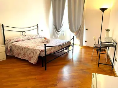 a bedroom with a bed and a wooden floor at Ammiragli Vatican Experience in Rome