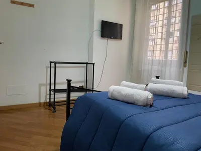 a bedroom with a blue bed with towels on it at Ammiragli Vatican Experience in Rome