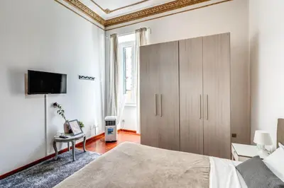 a bedroom with a large wooden cabinet and a bed at Corso Trieste 62 in Rome