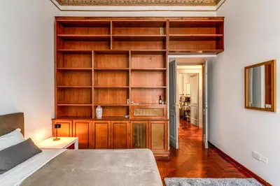a bedroom with a large wooden book shelf at Corso Trieste 62 in Rome