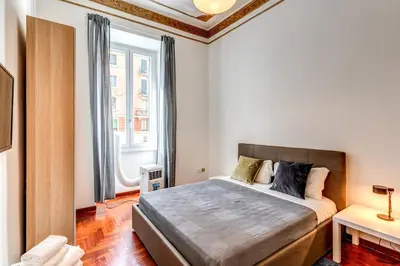 a bedroom with a large bed and a window at Corso Trieste 62 in Rome