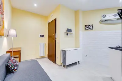 a living room with a couch and a door at Monteverde Cozy Apartment in Rome
