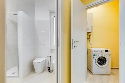 a bathroom with a washer and dryer in it at Monteverde Cozy Apartment in Rome