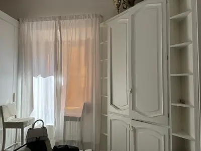 a white cabinet in a room with a window at DOLCE VITA VIMINALE ROOM in Rome