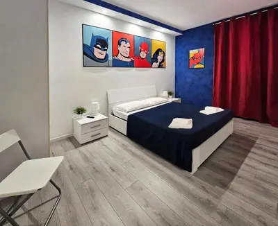 a bedroom with a bed and paintings on the wall at APT Re di Roma in Rome