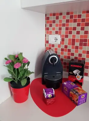 a desk with a computer mouse and a potted plant at APT Re di Roma in Rome