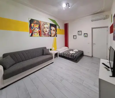 a living room with a couch and a bed at APT Re di Roma in Rome