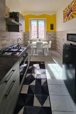 a kitchen with a table and a counter top at APT Re di Roma in Rome