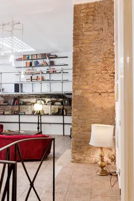 a room with a table and a brick wall at Navona Glamour Apartment in Rome