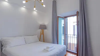 a bedroom with a bed and a large window at EasyTopStay - Piazza Navona Elegant Apartment in Rome