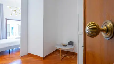 a room with a door and a small table at EasyTopStay - Piazza Navona Elegant Apartment in Rome