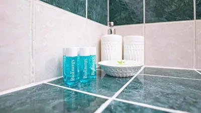 a bathroom counter with two bottles and a sink at EasyTopStay - Piazza Navona Elegant Apartment in Rome