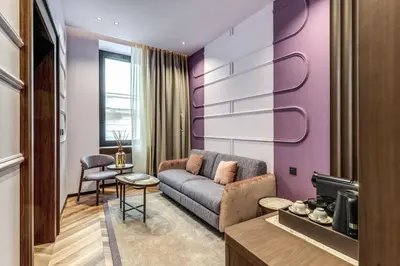 a living room with a couch and a table at THE STEPS Hotel - by Eitch Collection in Rome