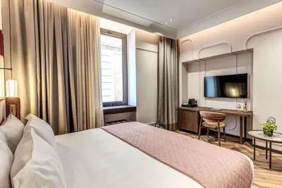 a hotel room with a bed and a desk at THE STEPS Hotel - by Eitch Collection in Rome