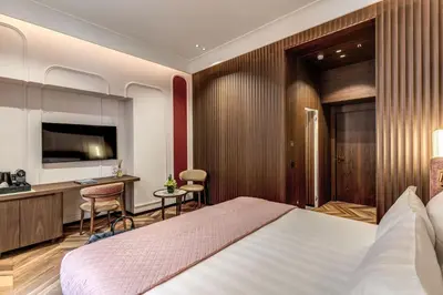 a hotel room with a large bed and a desk at THE STEPS Hotel - by Eitch Collection in Rome