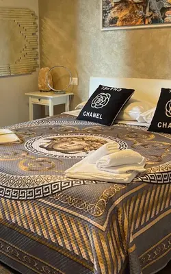 a bed with a blanket on top of it at PARIOLI LUXURY HoME in Rome