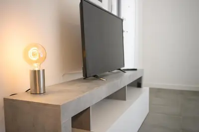 a tv on a shelf with a television on it at Laura Sweet Home con Piscina in Rome