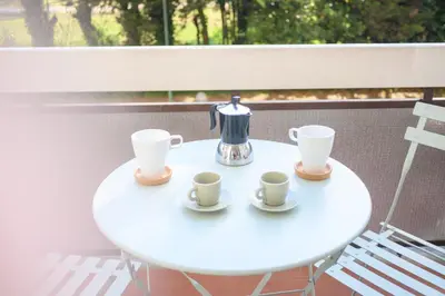 a white table with two cups and a tea kettle at Laura Sweet Home con Piscina in Rome