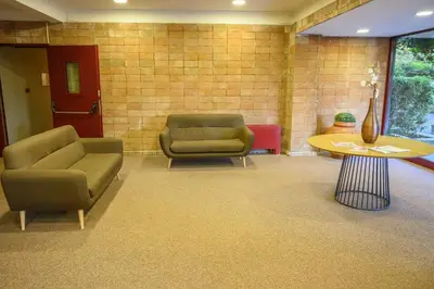 a waiting room with two chairs and a table at Laura Sweet Home con Piscina in Rome
